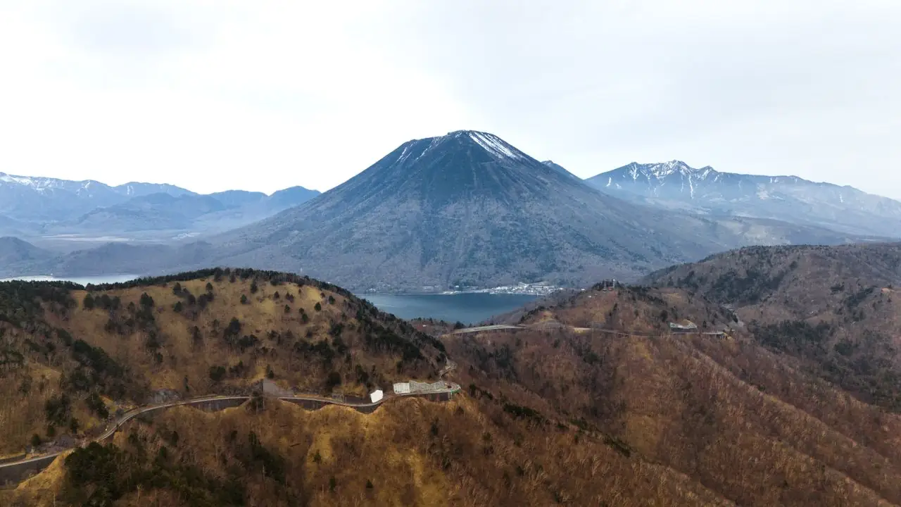 Mount Nantai rising above Lake Chuzenji with a mountain road in the foreground