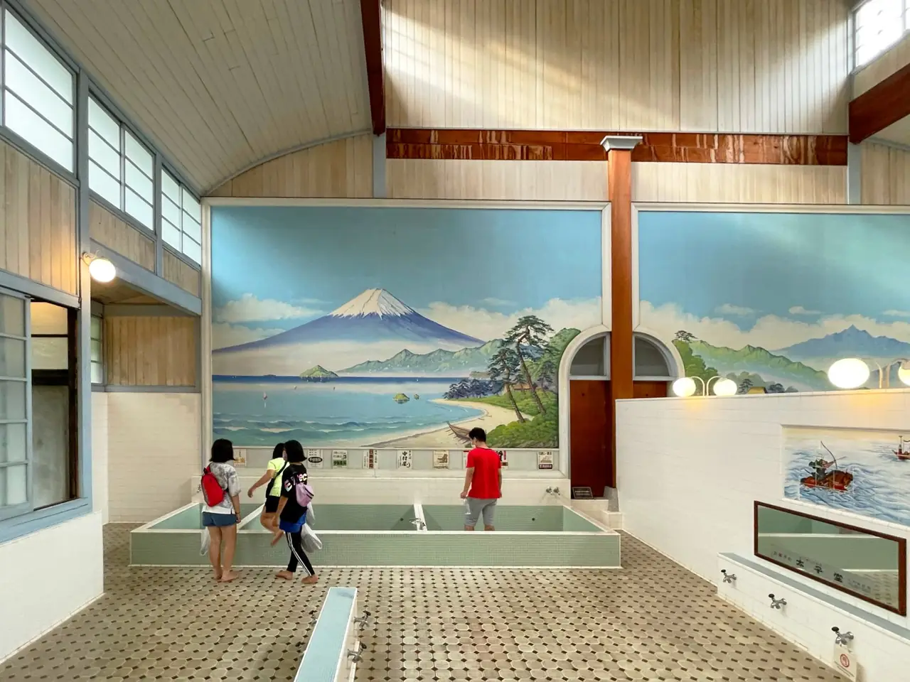 The men's bath hall at Kodakara-yu, now a museum, with a Mt. Fuji mural above the tubs