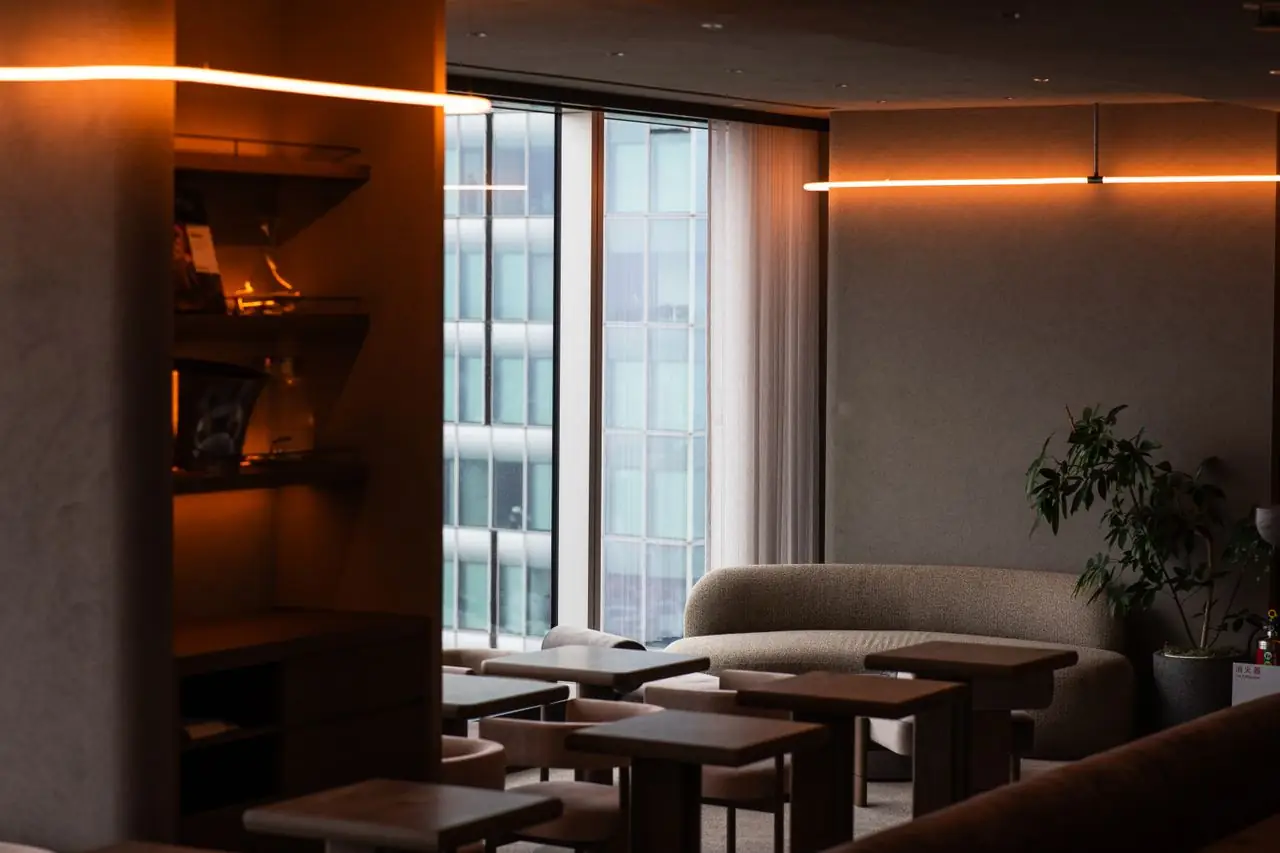 Quiet lounge seating beside tall windows in a modern Tokyo hotel