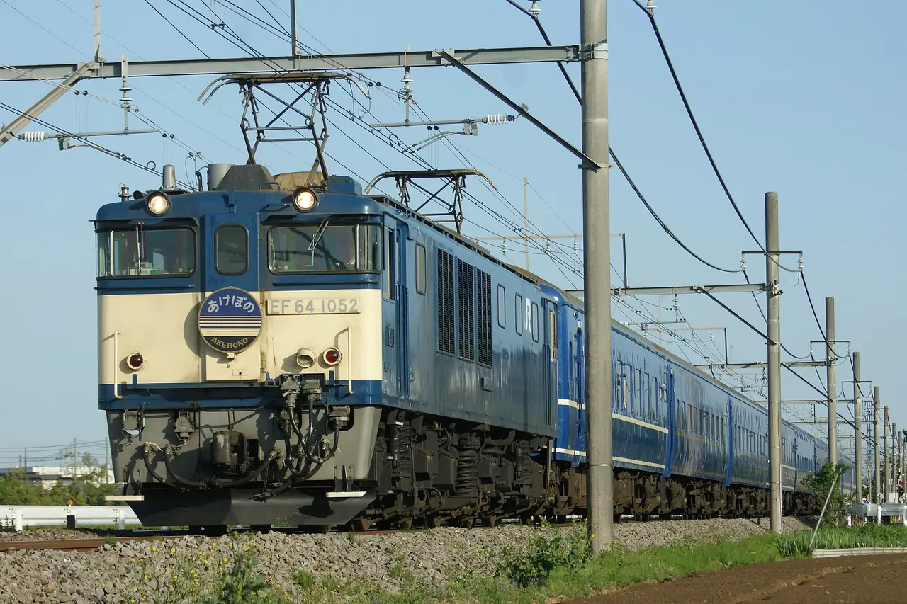 Blue sleeper cars of the Akebono overnight express hauled by an electric locomotive