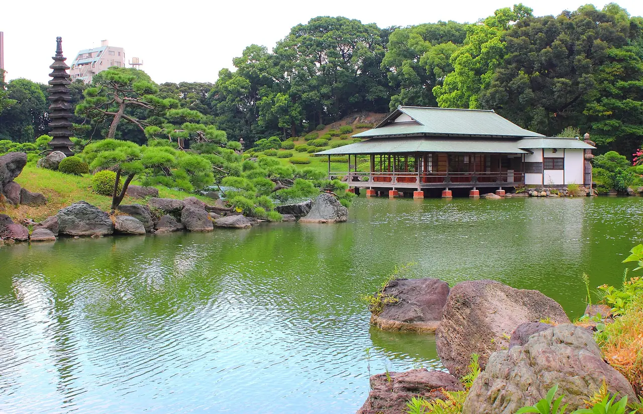 Calm pond and lakeside teahouse at Kiyosumi Teien garden in Koto, Tokyo
