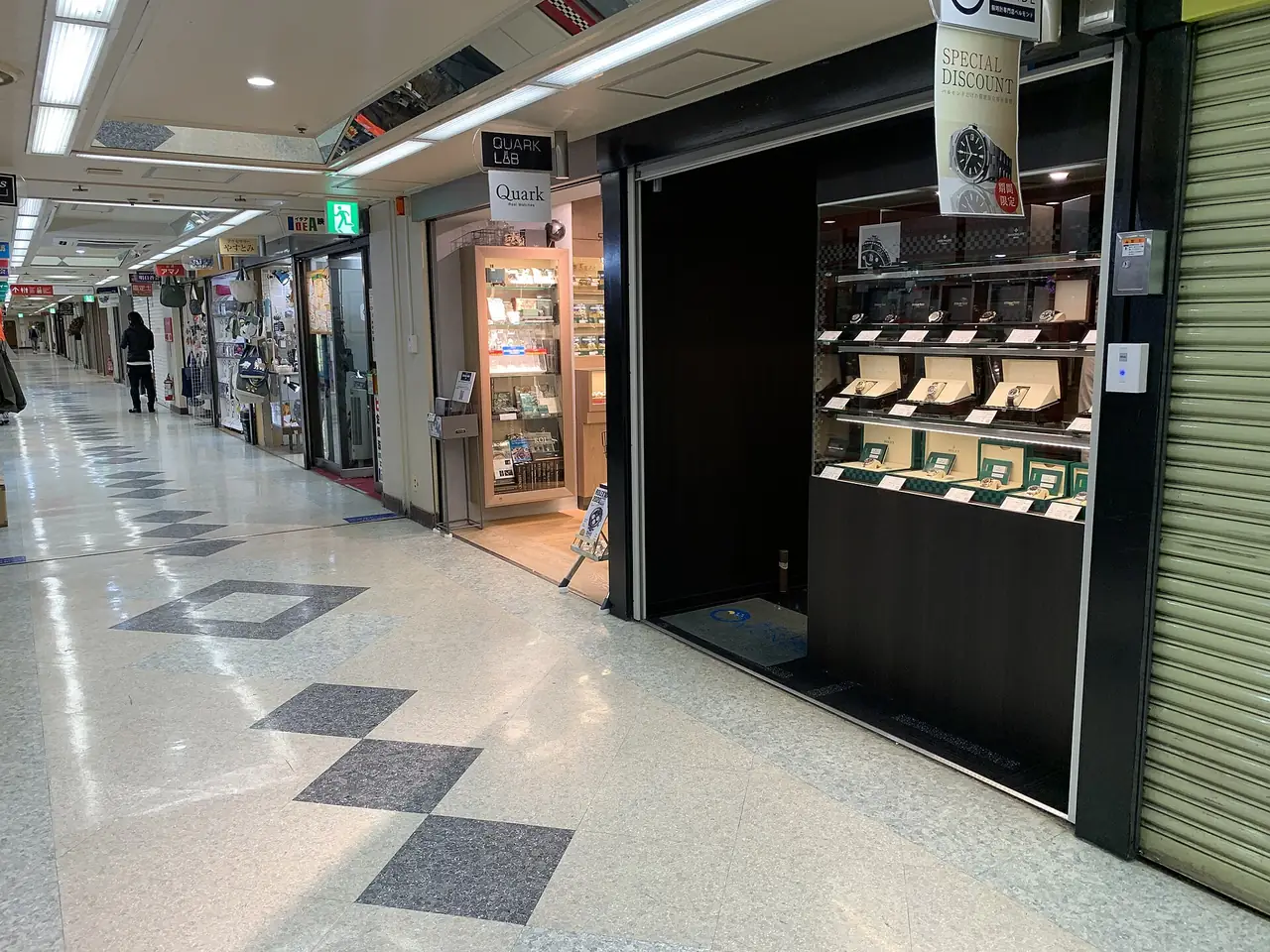 Quiet third floor corridor of Nakano Broadway lined with secondhand watch shops