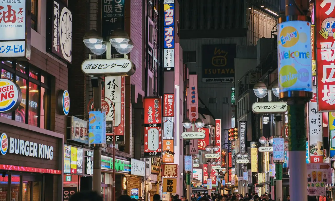 Neon signs and street lamps along Center-gai in Shibuya at night