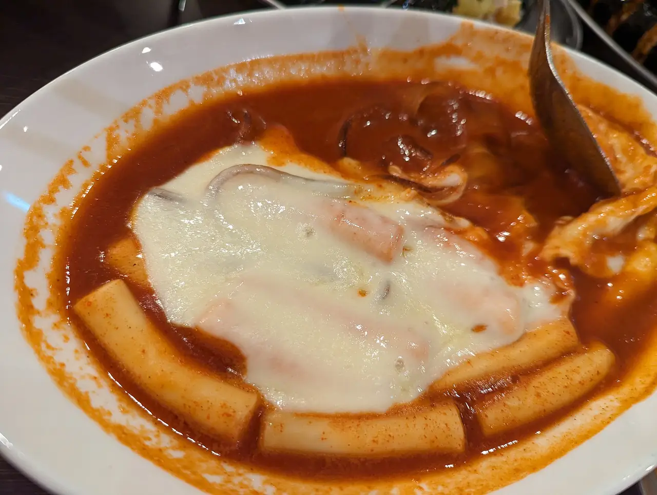 Cheese-topped tteokbokki rice cakes at a restaurant in Shin-Okubo