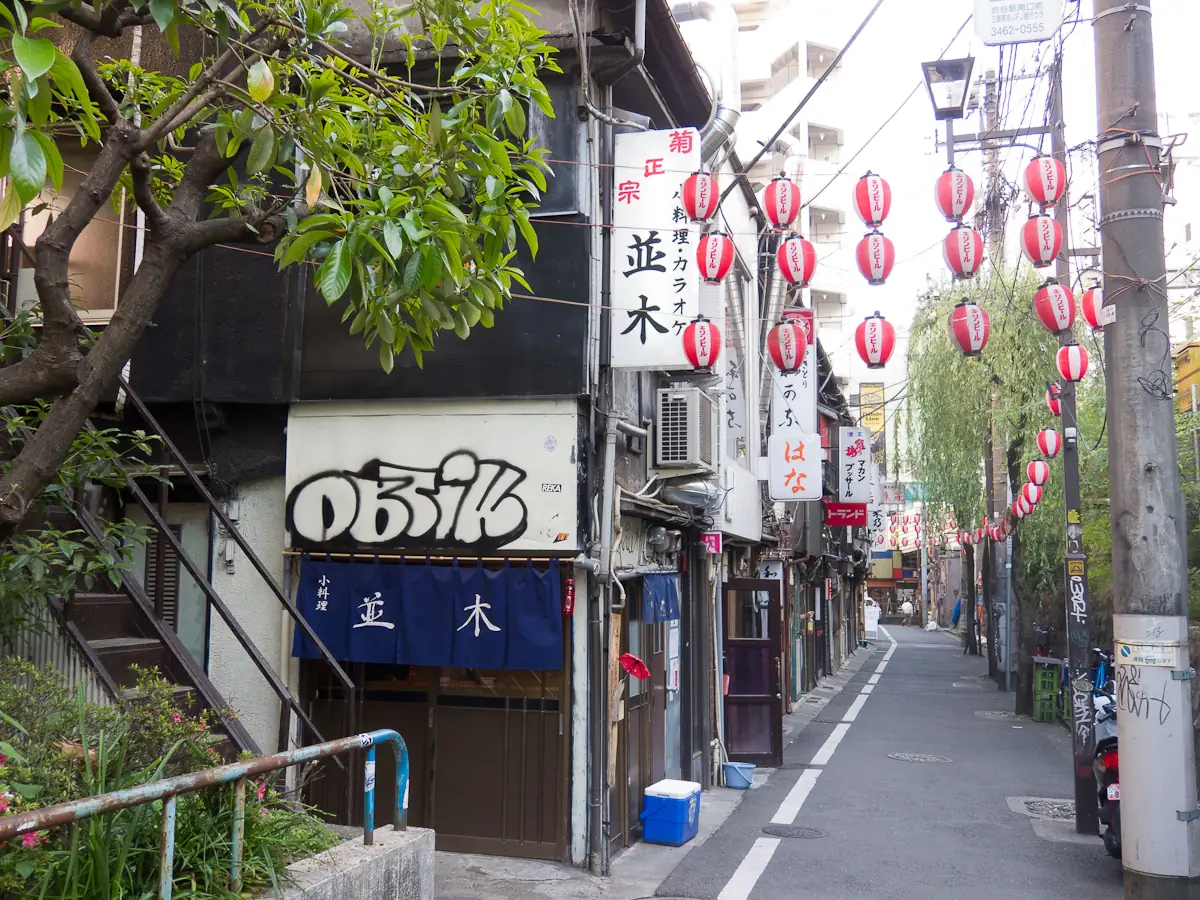 Paper lanterns strung over the narrow lane of Nonbei Yokocho in Shibuya