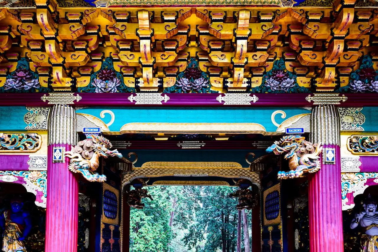 The richly painted gateway of Taiyu-in temple among the cedars of Nikko