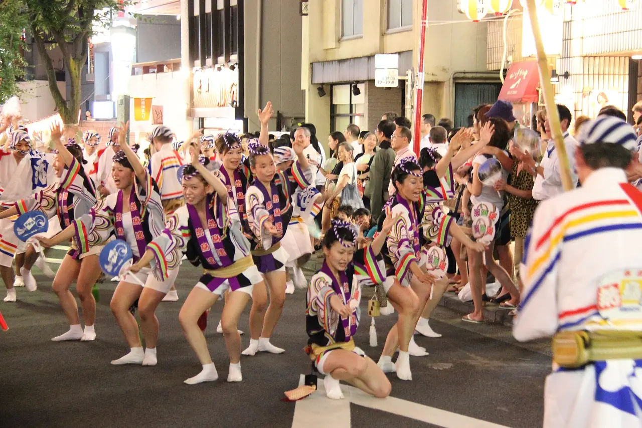 Awa Odori dancers in matching yukata parading down Kagurazaka-dori during the summer festival