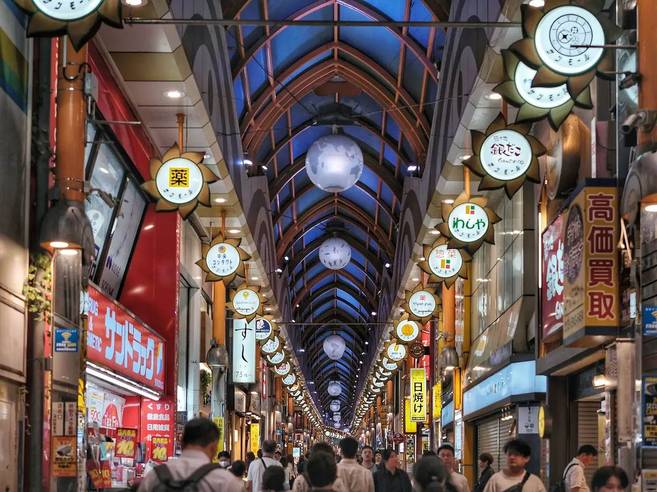 Shoppers under the arched glass roof of the Nakano Sun Mall arcade