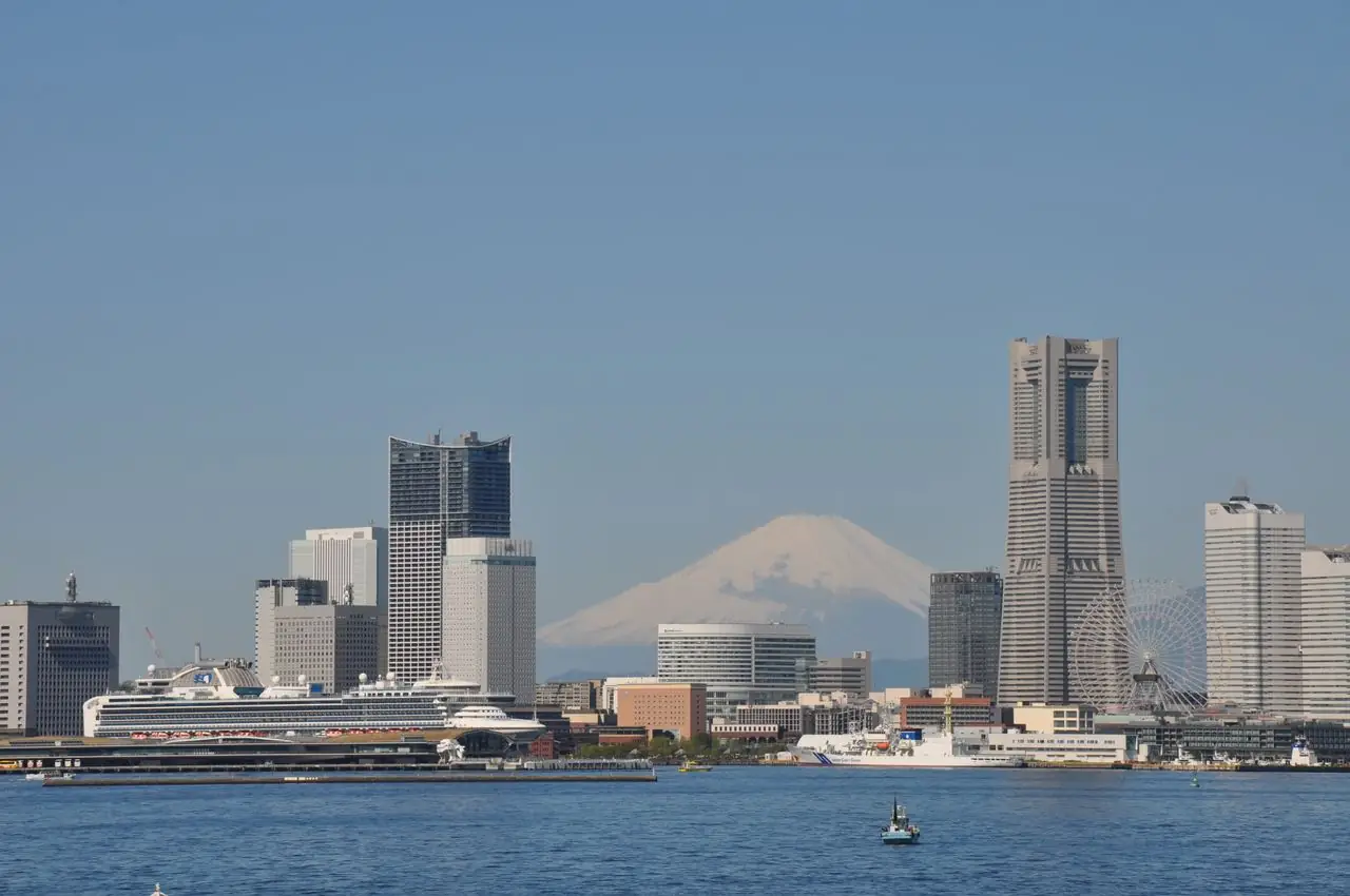 Cruise ship docked on the Yokohama waterfront below Landmark Tower, with Mount Fuji behind