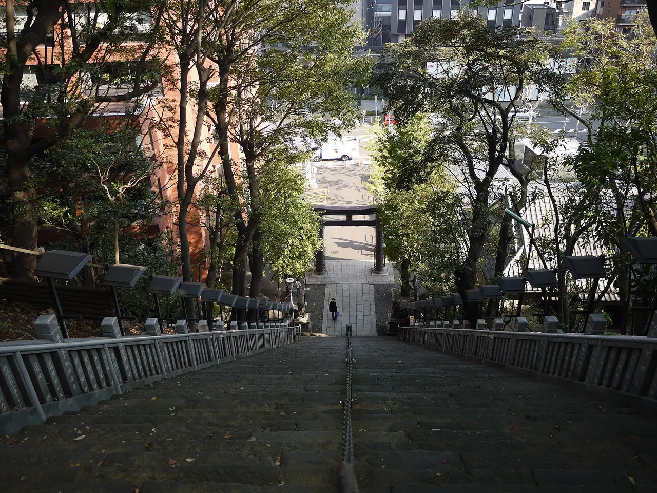 Looking down the steep stone stairs of Atago Shrine toward the street below